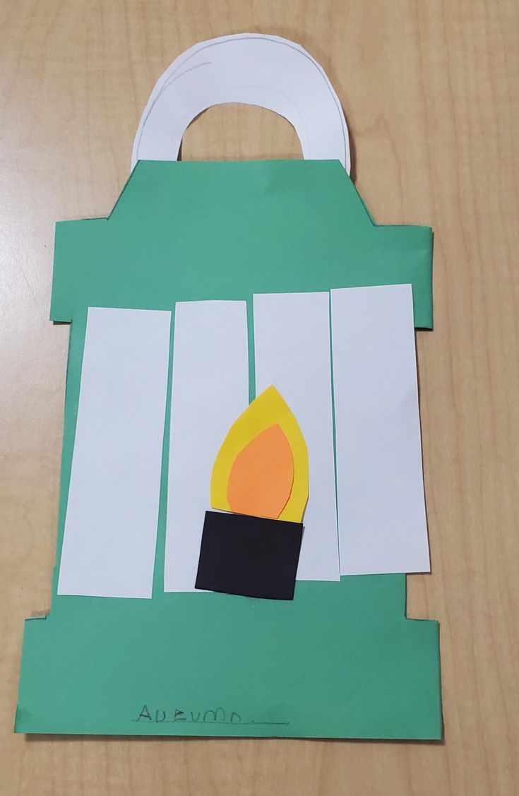 a paper bag with a fire in the fireplace cut out on it's side