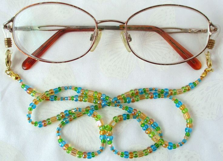 Never leave your reading glasses behind - use this yellow/multicolor beaded eyeglass chain! 24.5" in length, made with glass beads, beading cord, metal lobster clasps, and adjustable rubber holders. Lobster clasps make it easy to change the rubber holders, and an extra pair of holders included with every purchase. This bright yellow/multicolor beaded eyeglass chain will arrive in a gift box, ready to give as a present or to keep and store. Back to Beaded Eyeglass Chains Beaded Eyeglass Chain, Beading Cord, Eyeglass Chain, Eyewear Accessories, Bright Yellow, Reading Glasses, Colored Glass, Cat Eye Glass, Different Colors