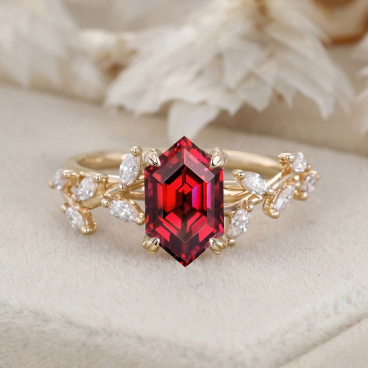 a close up of a ring with a red stone in the middle and white stones around it