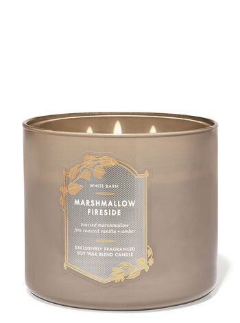 a candle that is sitting in front of a white background with the words marshmallow inside