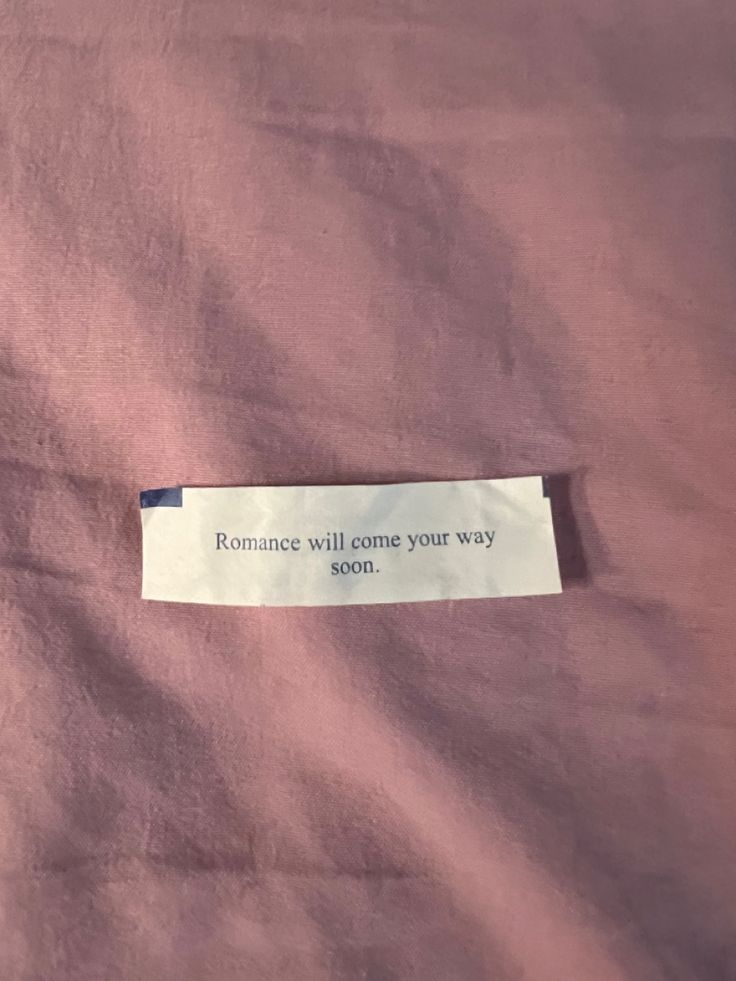 a piece of paper that says, romance will come your way on the pink background