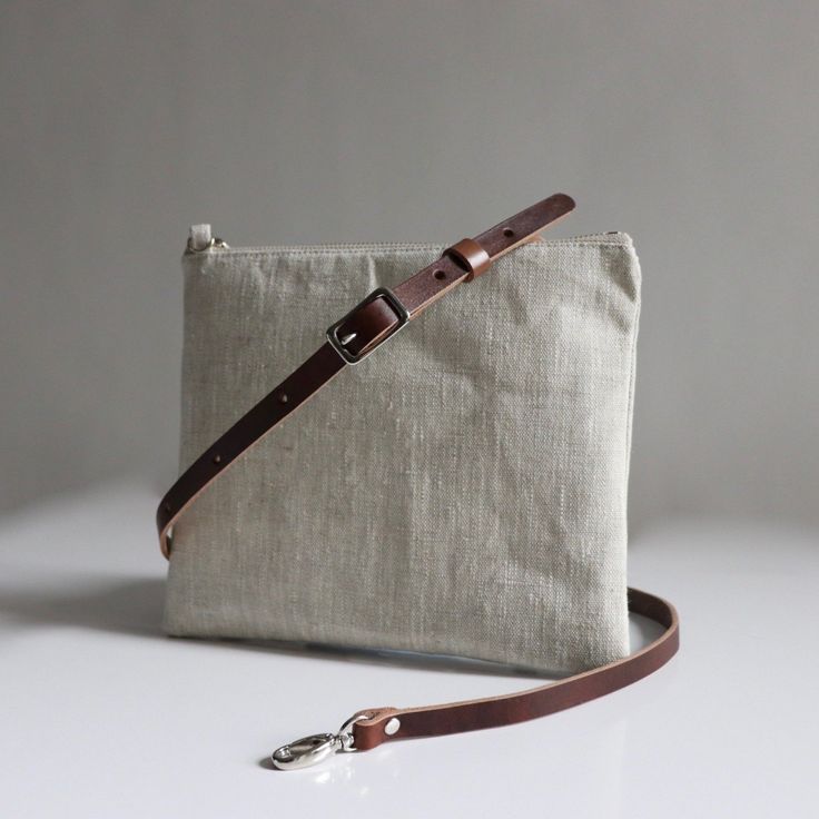 Our simple crossbody bag with adjustable leather strap in natural, textured linen is neutral in color, super lightweight and durable enough for everyday use. Simple Crossbody Bag, Kavu Bag, Crossbody Bag Pattern, Vacation Bag, Casual Date, Bag Patterns To Sew, Brown Leather Strap, Dark Brown Leather, Cross Straps