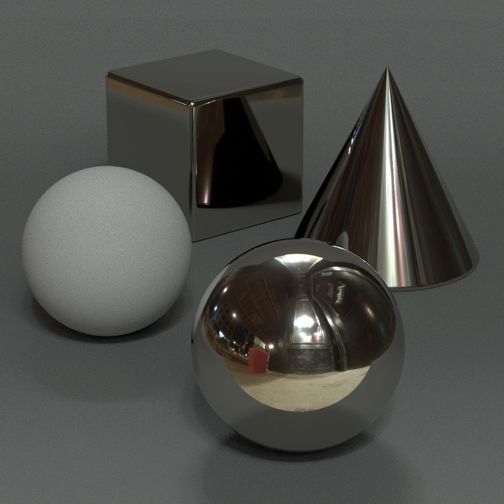 an egg is sitting next to two silver objects on a gray surface with a white ball in the middle