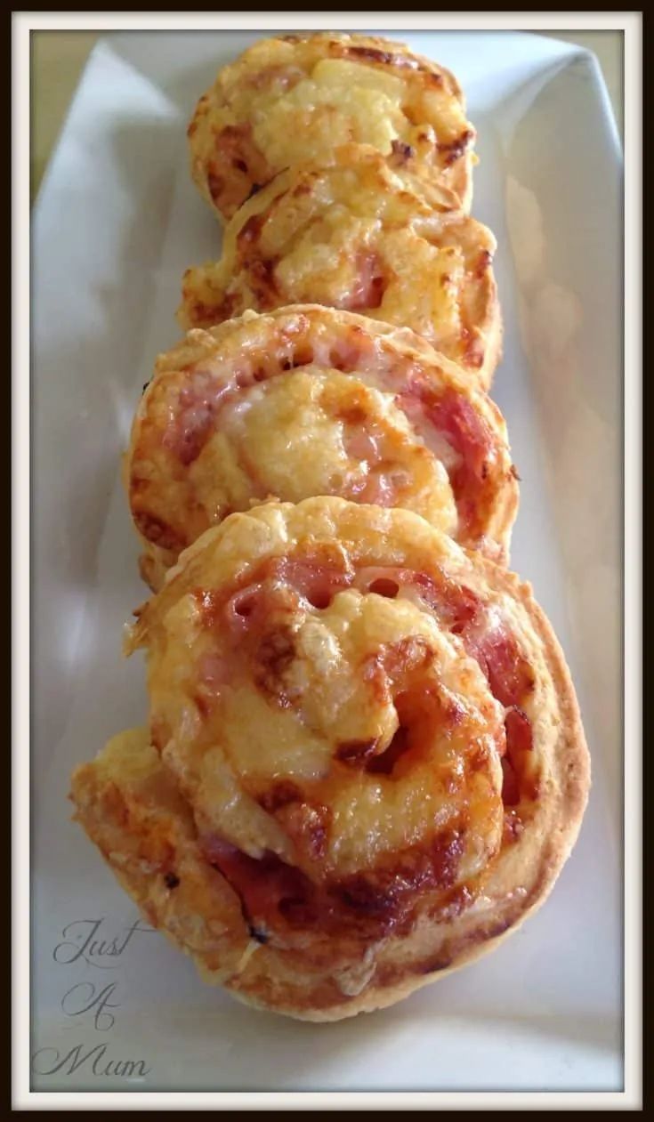 three pastries sitting on top of a white paper wrapper in a black frame