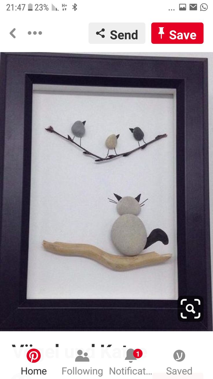 three birds sitting on top of a branch next to a rock in a shadow box