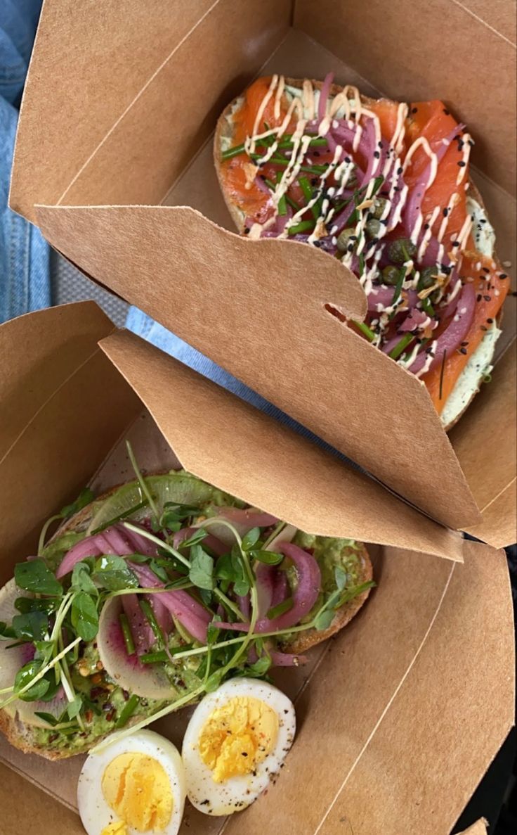 two open boxes filled with food sitting next to each other