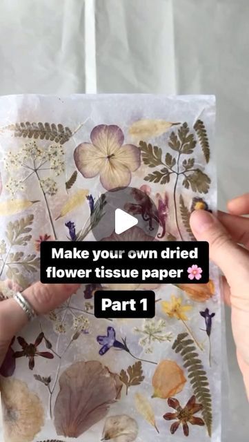 a person holding up a piece of paper with flowers on it and the words make your own dried flower tissue paper part 1