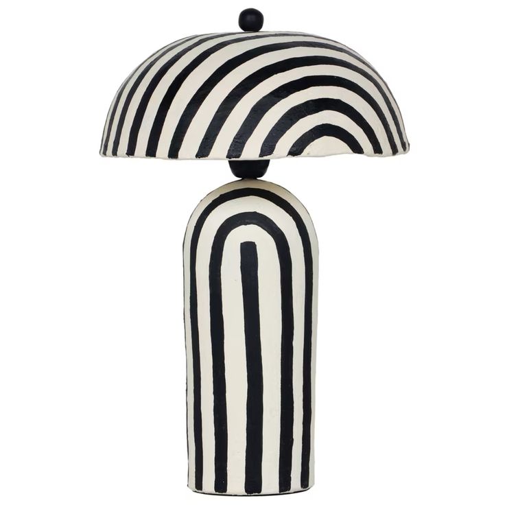 a black and white lamp with a striped shade on the top, sitting in front of a white background