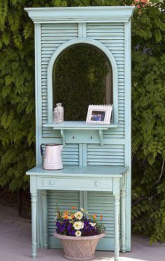 a blue dresser with a mirror on it