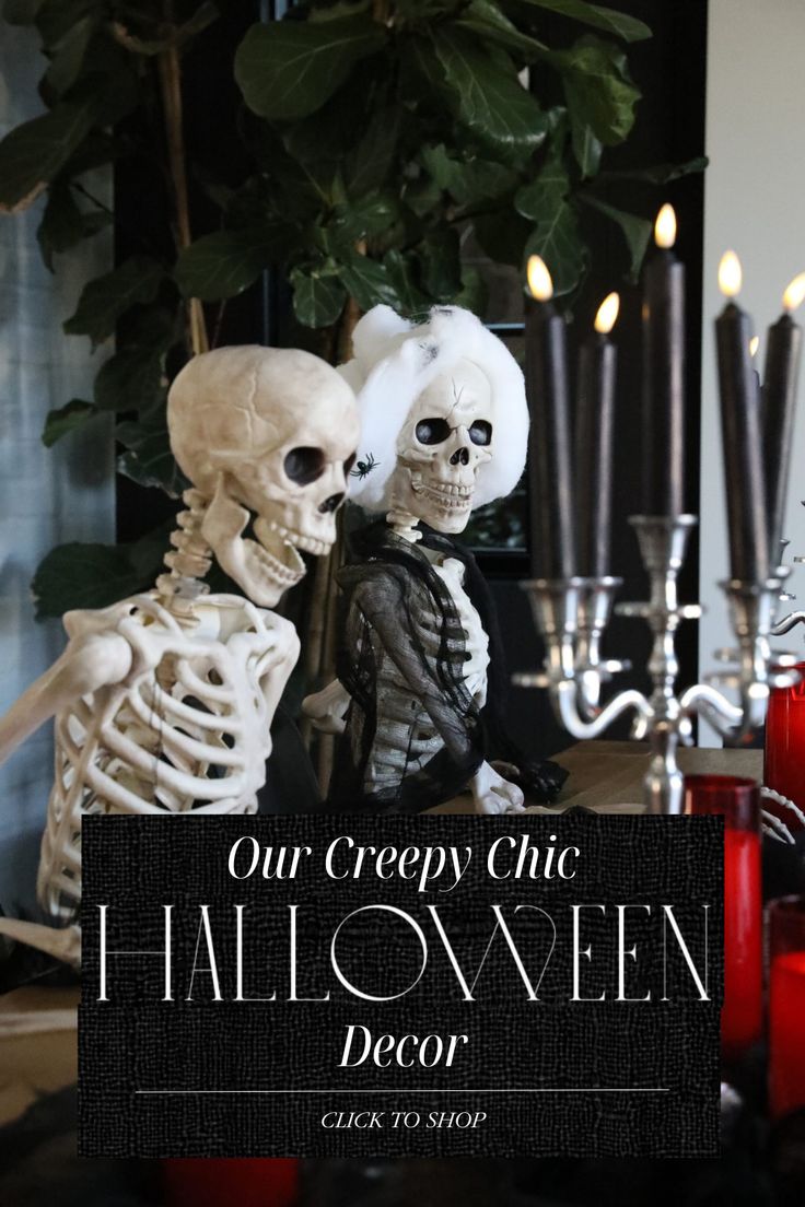 two skeletons sitting next to each other in front of candles and a sign that says our creepy chic halloween decor