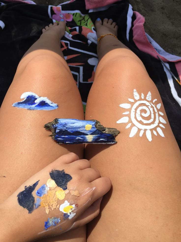 someone has their legs covered with paint and sun on the other side of her body