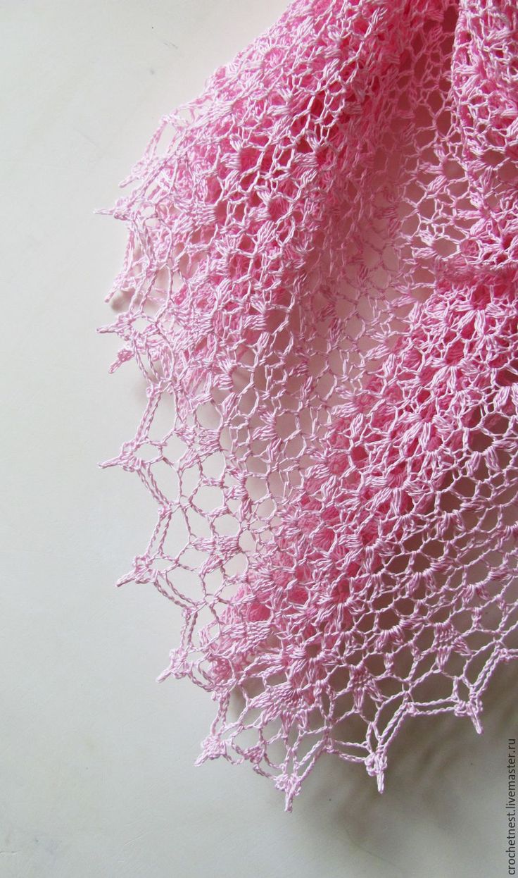 pink crocheted shawl on white surface