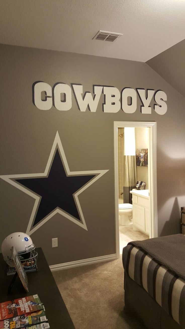 a bedroom with a football themed wall decal