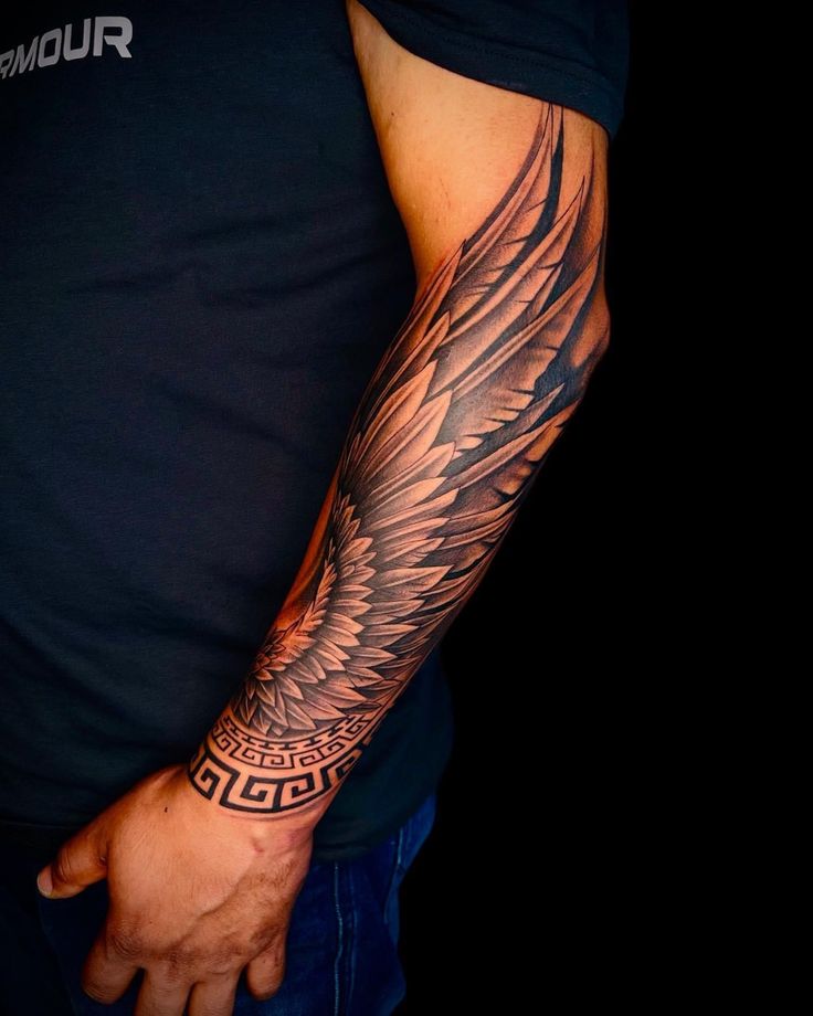 a man's arm with an eagle tattoo on it