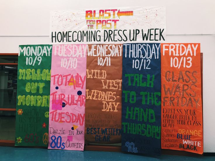 three colorful banners with writing on them in front of a door that says, home coming dress up week