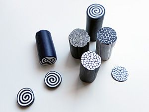 several black and white objects are arranged on a white surface, including one with circles