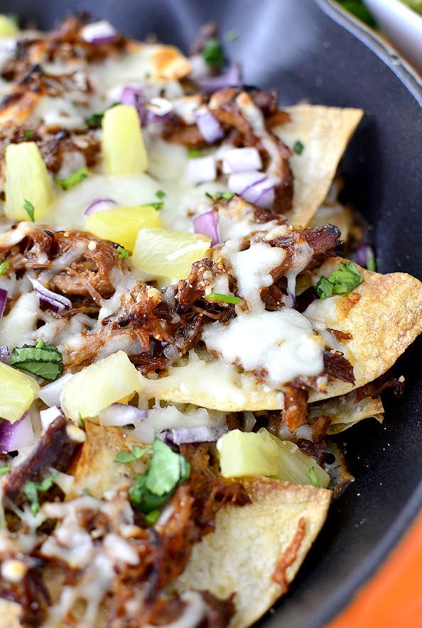 nachos with meat, cheese and onions in a skillet