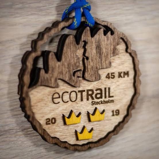 a wooden ornament hanging on a wall with the name ecotrail in it