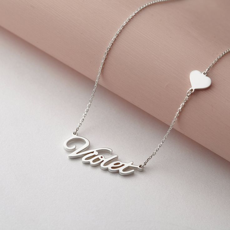 "Customized with any name, this silver necklace will make a great gift for your family and friends ♥ ► CURSIVE NAME NECKLACE WITH HEART * Material: High Quality Solid 925 Sterling Silver * Finishing: Silver, Gold or Rose Gold. * Word limits: up to 9 characters for best visibility. * All of our jewelry are handmade from scratch and packaged with care in our workshop ► HOW TO ORDER & ADD PERSONALIZATION - Add the item to cart and check out. During check-out, include in the \"Note to Seller\" b Silver Necklaces For Personalized Gifts, Sterling Silver Name Charm Necklace For Birthday, Sterling Silver Name Charm Necklace For Birthday Gift, Customized White Name Necklace For Valentine's Day, White Name Necklace For Mother's Day Or Birthday, Sterling Silver Name Necklace For Birthday, White Name Necklace For Birthday And Mother's Day, Sterling Silver Custom Name Necklace For Birthday, Customizable Charm Necklaces For Birthday And Valentine's Day