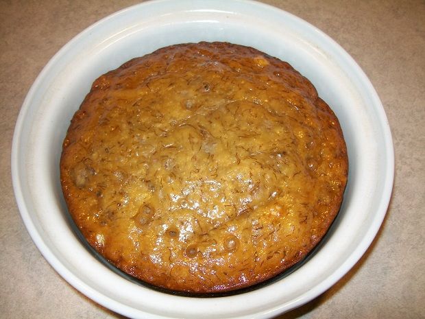 a white bowl filled with food on top of a table