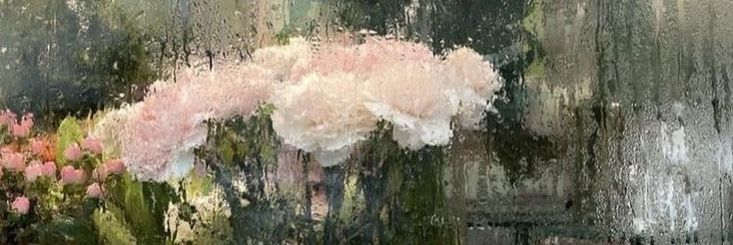 a vase filled with pink flowers sitting on top of a window sill covered in rain