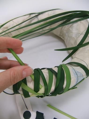 someone is making a wreath out of strips of paper