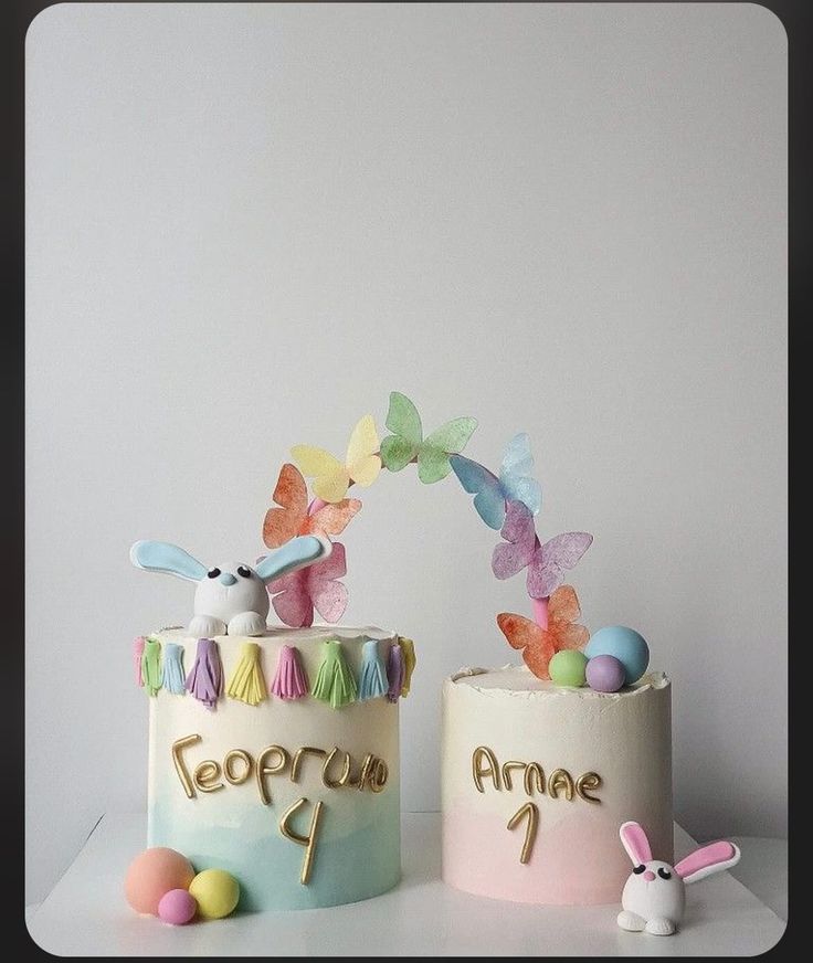 two cakes decorated to look like animals and butterflies