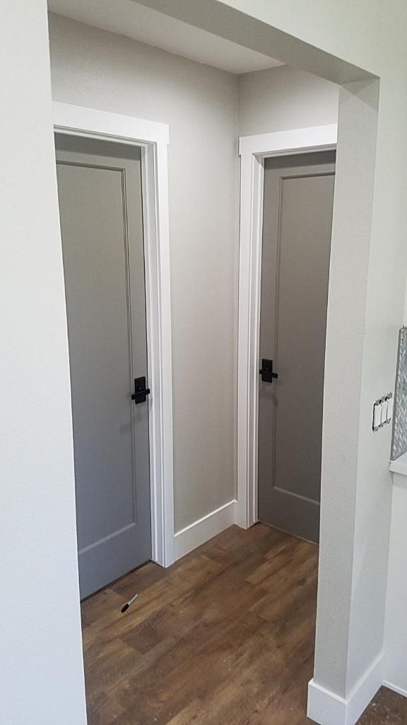 an empty room with white walls and wooden floors