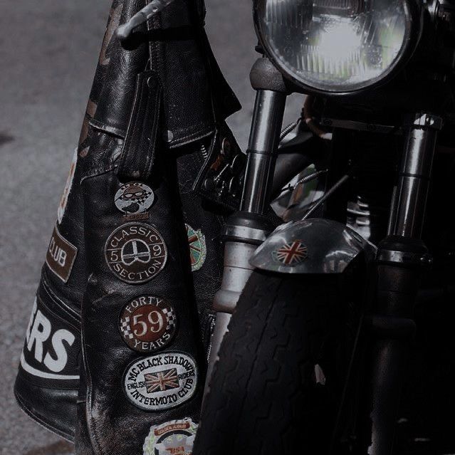 a close up of a motorcycle with badges on it