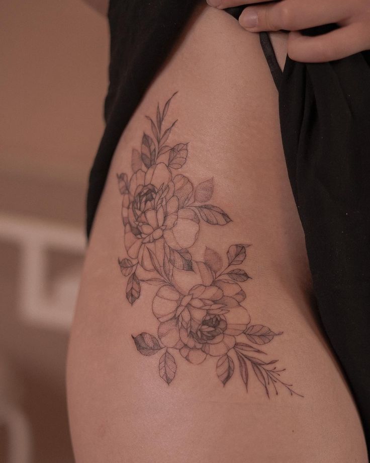 a close up of a woman's stomach with flowers on it