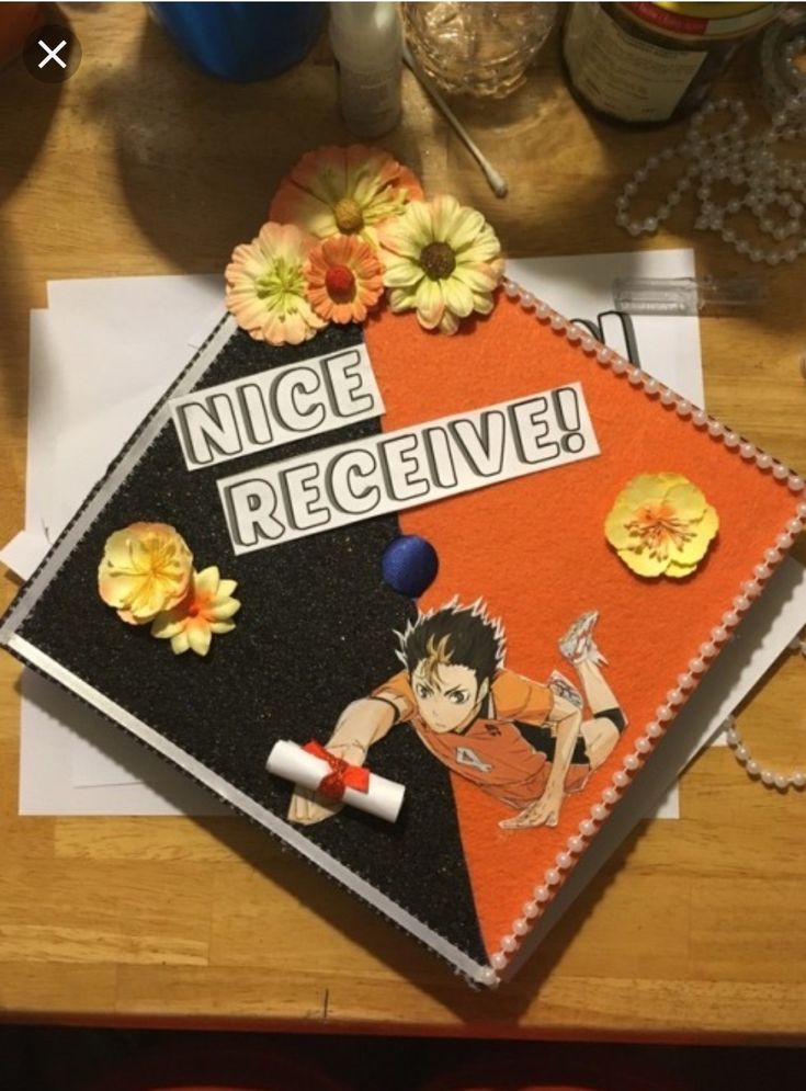 an orange and black notebook with the words nice receive on it next to some flowers