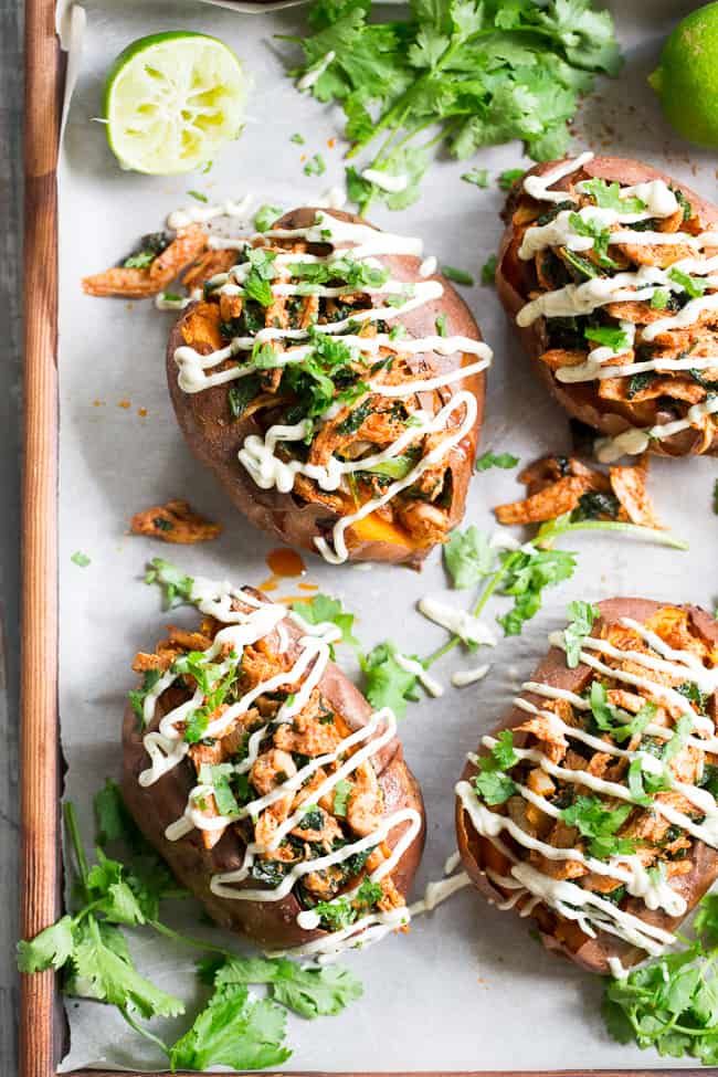 baked sweet potatoes topped with taco sauce and cilantro