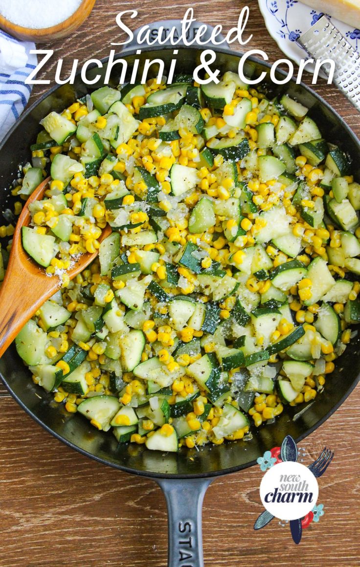 a skillet filled with cucumbers and corn on top of a wooden table