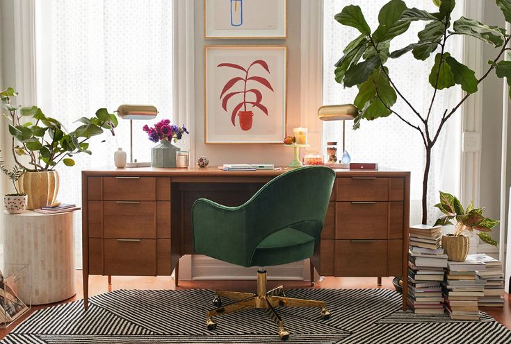 a room with a desk, chair and plants on the floor in front of it