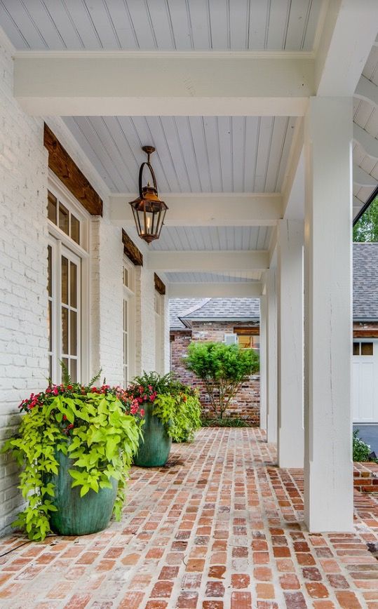 the front porch is clean and ready to be used as a place for entertaining guests