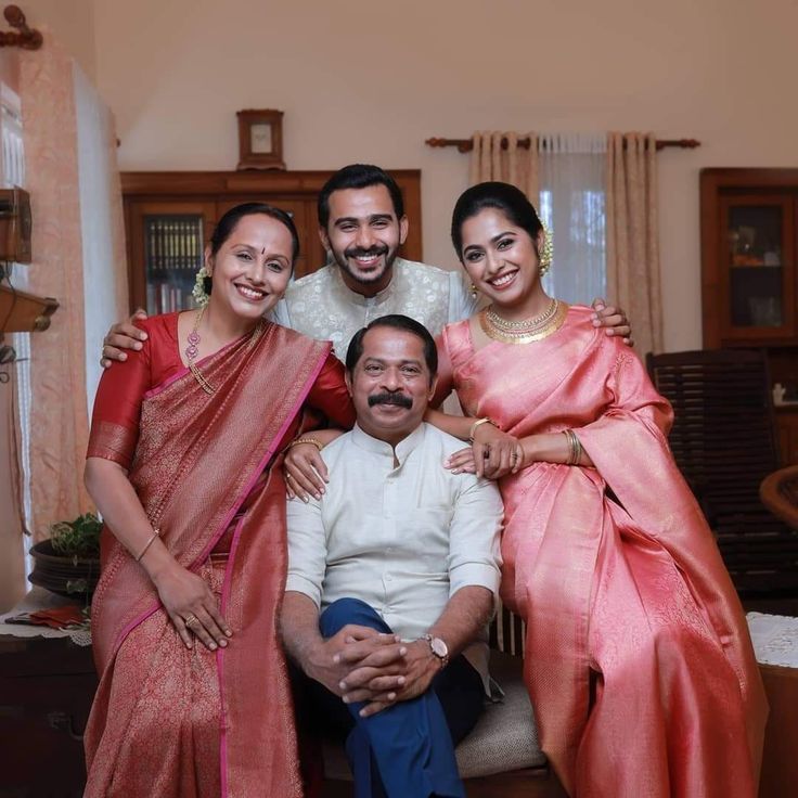 the family is posing for a photo in their home