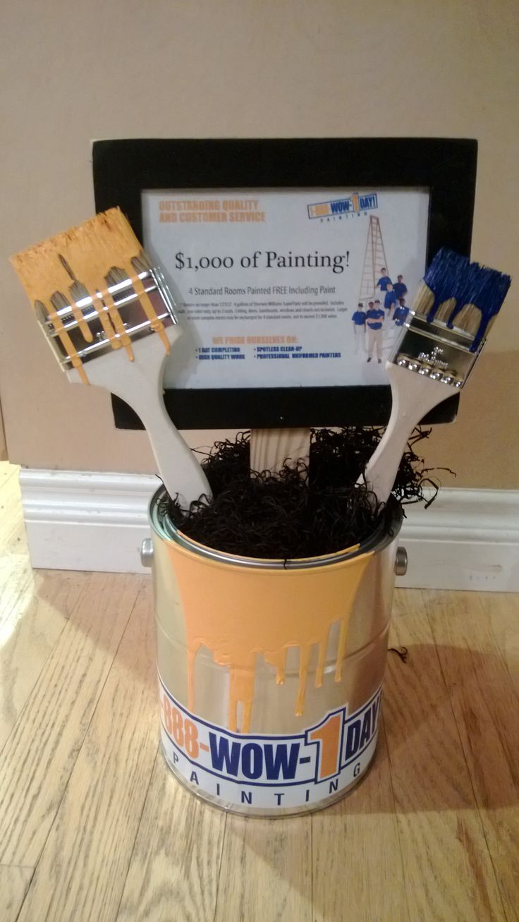 there is a bucket with paint brushes in it