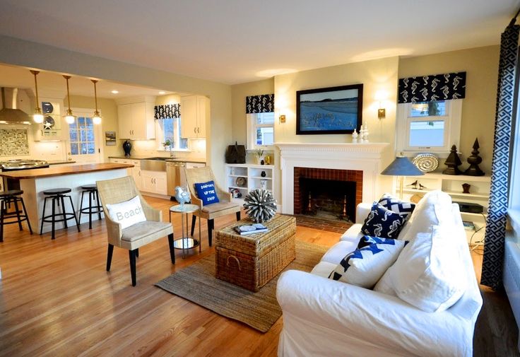 a living room filled with furniture and a fire place under a tv mounted on a wall