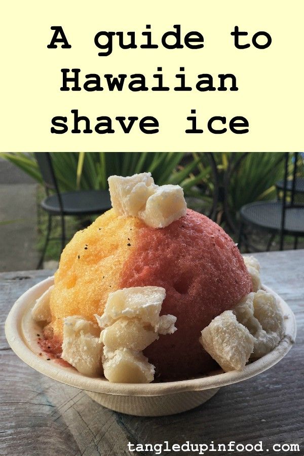 a bowl filled with ice cream sitting on top of a wooden table