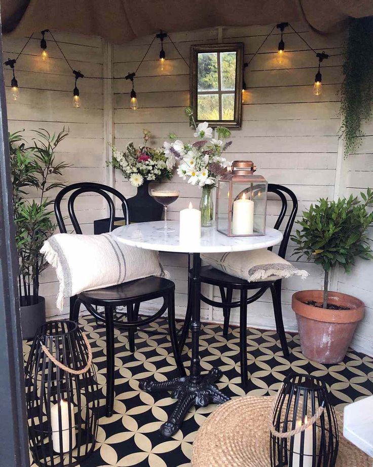 a table with two chairs and some plants