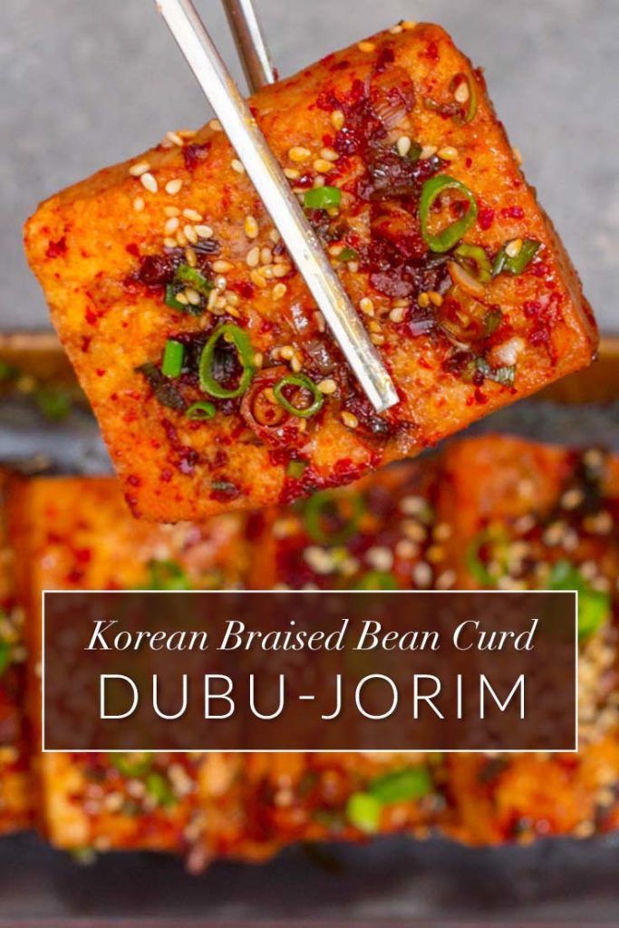 korean braised bean curd with chopsticks on top and the words, dubu - jormim above it