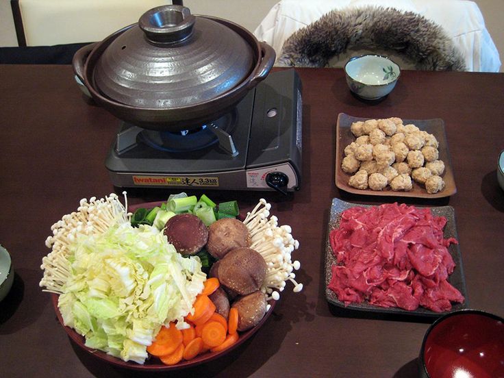 a table topped with bowls filled with different types of food next to a coffee pot