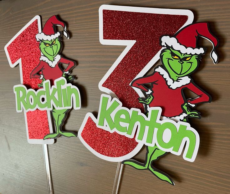 two red and green cake toppers with the number seven on them