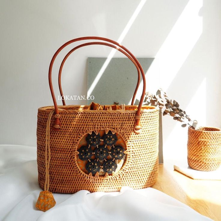 a straw bag sitting on top of a bed