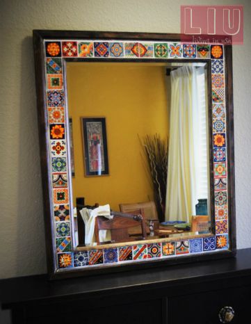 a mirror that is sitting on top of a wooden dresser in front of a yellow wall