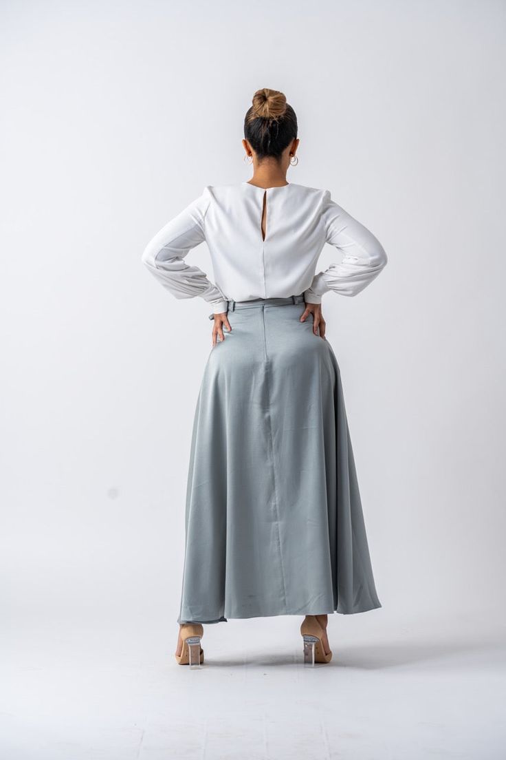 DESIGNED WITH YOU IN MIND Ameera Modest Wear is proud to offer our Belgrado Maxi skirt, a perfect addition to your wardrobe! You’ll never go wrong with a timeless maxi skirt. The semi-satin material and soft hue make this a design that you can dress up or down. Tuck in a white tee and slip on flats or sneakers one day or accompany it with heels and a ruffled blouse on another. Featuring an included belt, this womenʼs maxi skirt is flattering yet modest. Specifications: Fabric: polyester Non-stre Modest Lined Maxi Skirt For Work, Flowy Maxi Skirt For Workwear, Modest Maxi Length Lined Skirt, Modest Maxi Lined Skirt, Modest Flowy Maxi Skirt, Lined Maxi Skirt For Workwear, Ruffled Blouse, Slip On Flats, Modest Wear