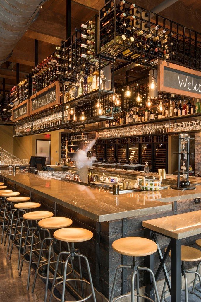 a bar with lots of bottles and stools