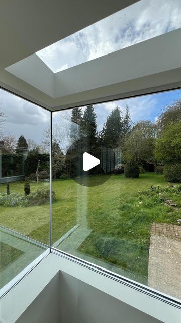 an open window looking out onto a green yard