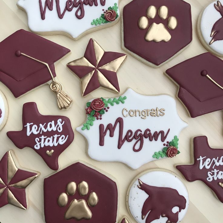 decorated cookies are arranged on a table with graduation caps and tassels in the shape of stars