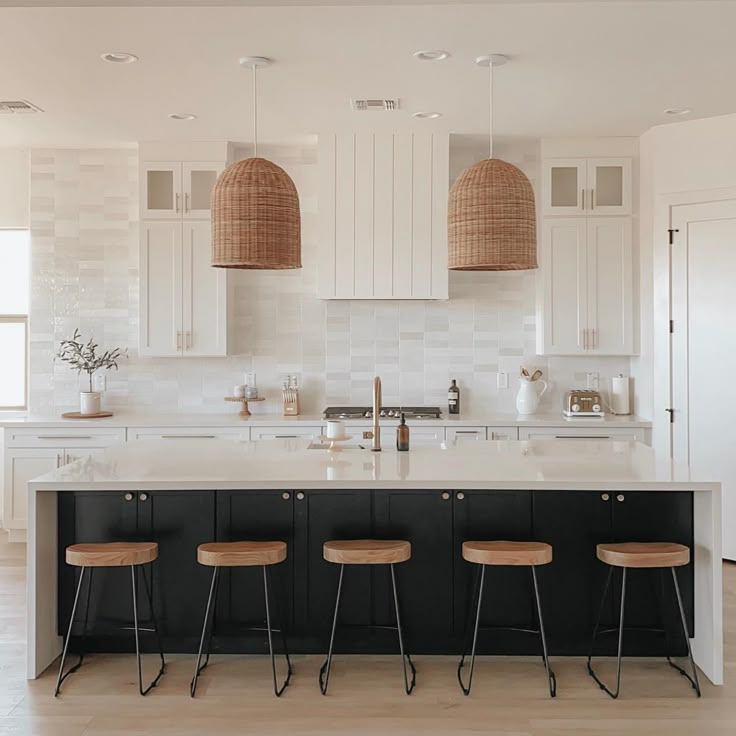 three stools sit at the center of a kitchen island